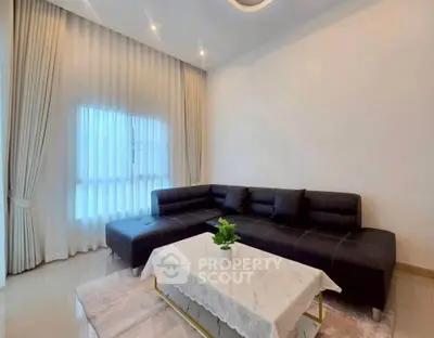 Elegant living room with modern black sectional sofa and chic decor