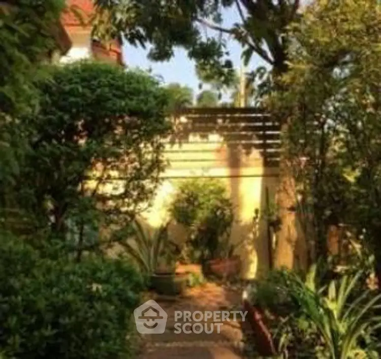 Charming garden pathway with lush greenery and serene ambiance