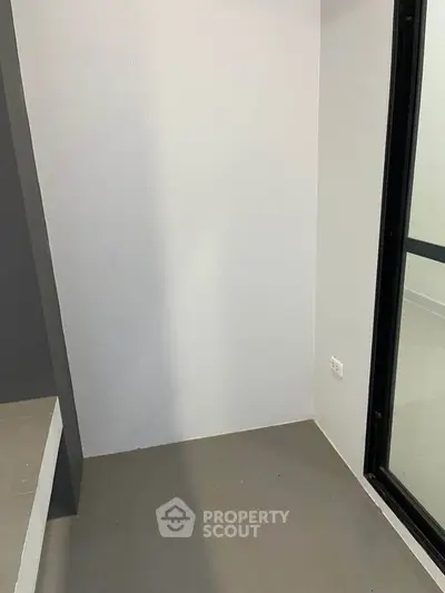 Minimalist corner space with sliding glass door and neutral tones, ideal for creative design opportunities.