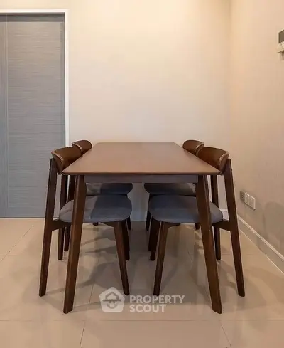 Modern dining area with sleek wooden table and chairs, perfect for contemporary living spaces.