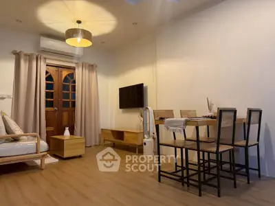 Charming living room with modern furniture and warm lighting, perfect for cozy gatherings.
