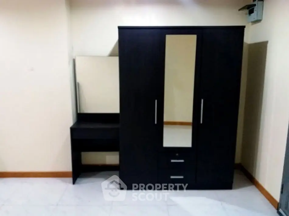 Spacious bedroom with modern wardrobe and vanity set