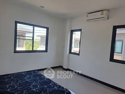 Spacious bedroom with large windows and air conditioning in modern home