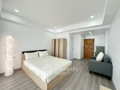 Spacious modern bedroom with minimalist design and cozy lighting