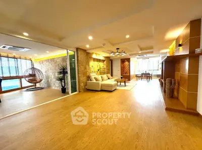 Spacious open-plan living room with modern decor and natural light