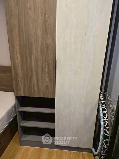 Modern bedroom with stylish wardrobe and wooden flooring