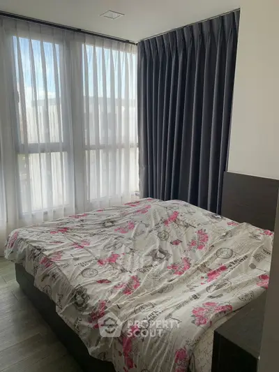 Cozy bedroom with large windows and elegant curtains in modern apartment