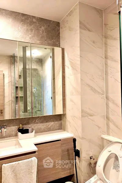 Modern bathroom with elegant marble tiles and sleek vanity unit