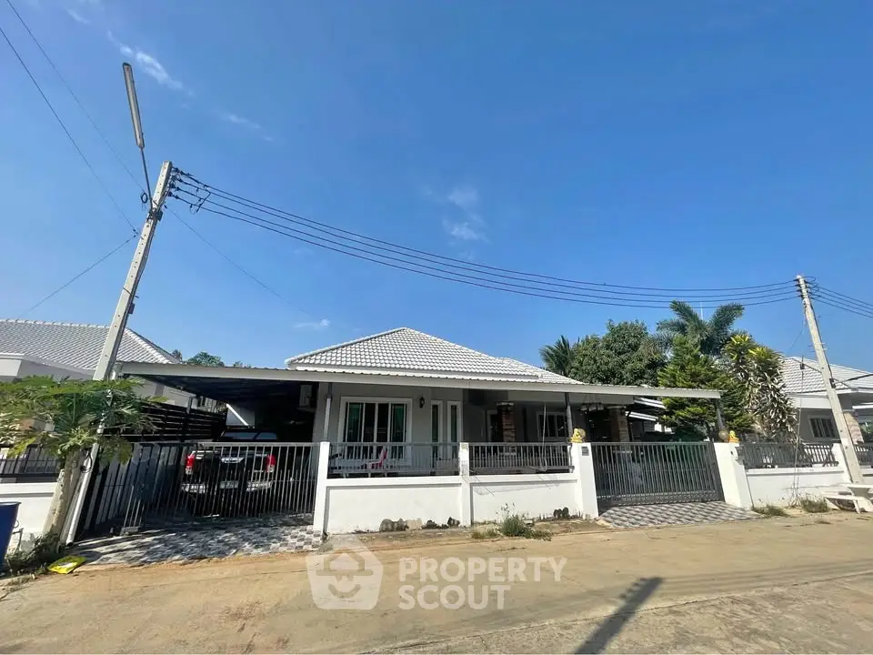 Charming single-story house with a spacious driveway and modern exterior design, perfect for family living.