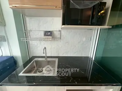 Modern kitchen with sleek black marble countertop and stainless steel sink