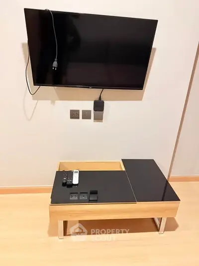 Modern living room with wall-mounted TV and sleek coffee table, perfect for contemporary urban living.