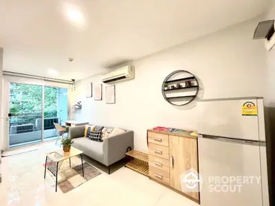 Modern living room with balcony view and stylish furniture in a bright apartment.