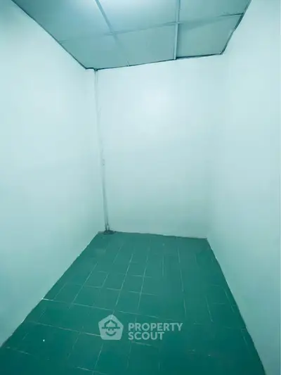 Minimalist small room with tiled floor and plain walls, ideal for storage or utility use.