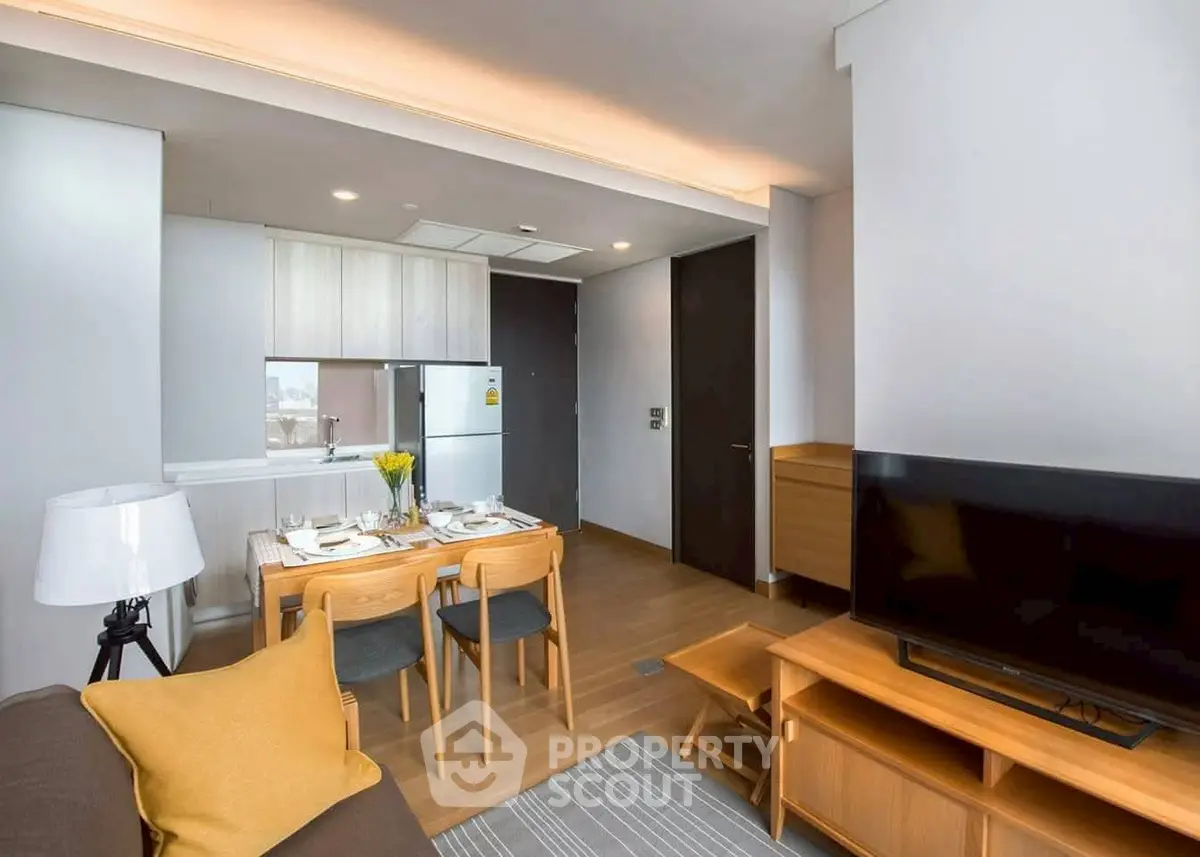 Modern living room with open kitchen layout and stylish decor in a cozy apartment.
