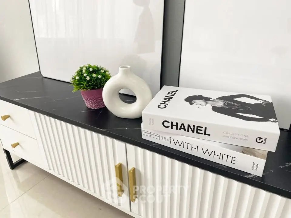 Stylish modern interior with elegant decor and books on a sleek console table.