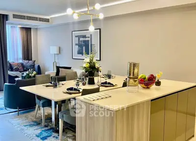 Modern open-plan living and dining area with elegant decor and stylish lighting.