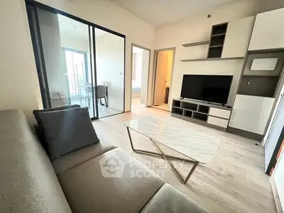 Modern living room with sleek furniture and glass partition, ideal for urban living.