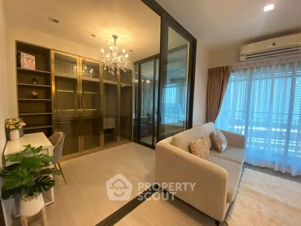 Luxurious living room with elegant chandelier and glass partition in modern apartment