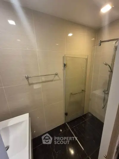 Modern bathroom with sleek glass shower and elegant tile design