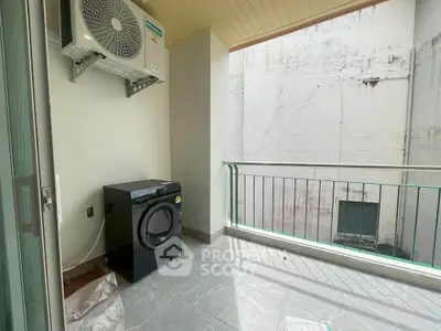 Charming balcony with laundry area and air conditioning unit, perfect for urban living.