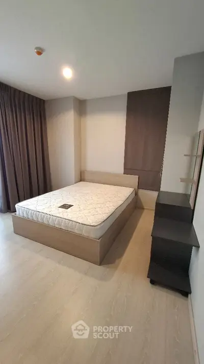 Modern minimalist bedroom with wooden flooring and large window curtains