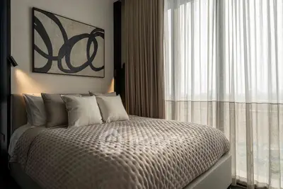 Luxurious bedroom with elegant decor and large window for natural light