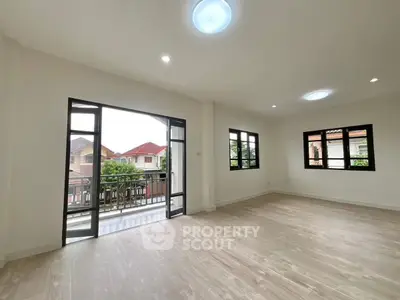 Spacious living room with balcony access and natural light in modern home