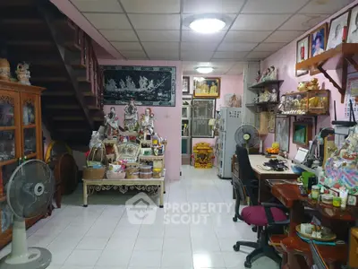 Charming living room with eclectic decor and wooden staircase in cozy home