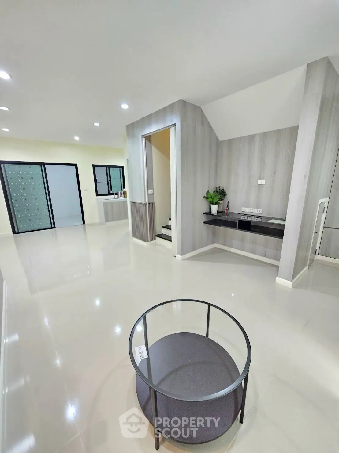 Modern living room with sleek design and open layout, featuring stylish furniture and elegant lighting.