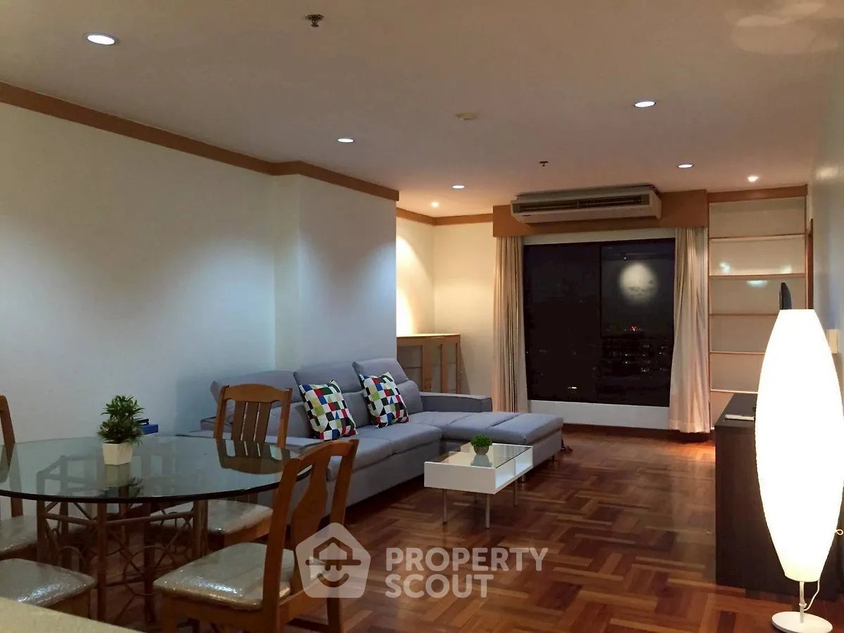 Spacious living room with modern decor and city view, perfect for urban living.