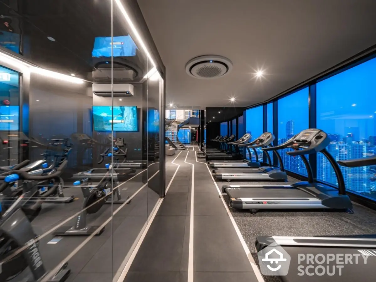 Luxury high-rise gym with panoramic city views and modern equipment