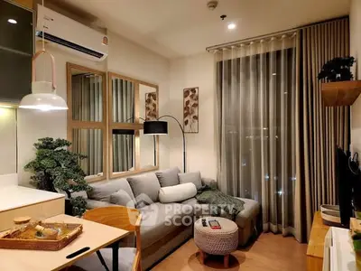 Cozy modern living room with stylish decor and large window view
