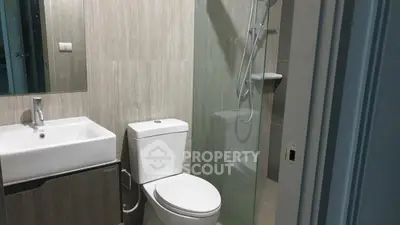 Modern bathroom with sleek fixtures and glass shower enclosure