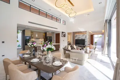 Luxurious open-plan living and dining area with modern decor and abundant natural light.