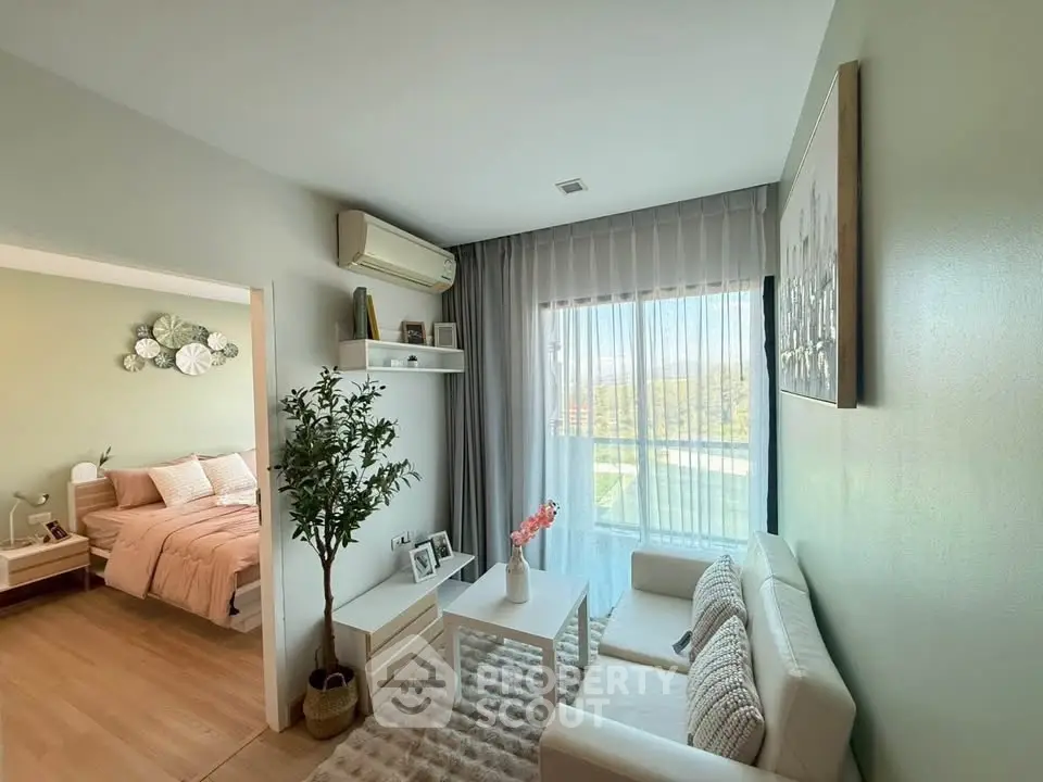 Cozy living room with modern decor and natural light, adjacent to a stylish bedroom.