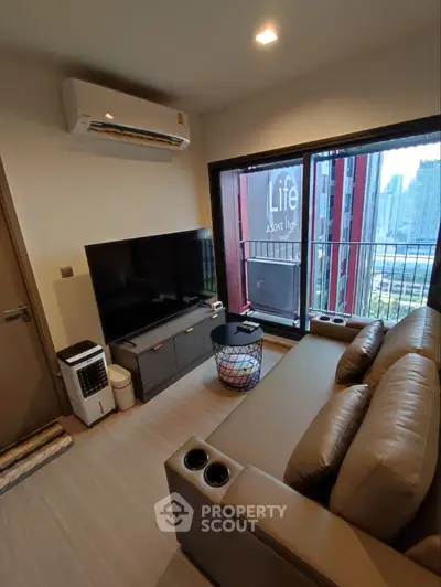 Modern living room with balcony view in high-rise apartment