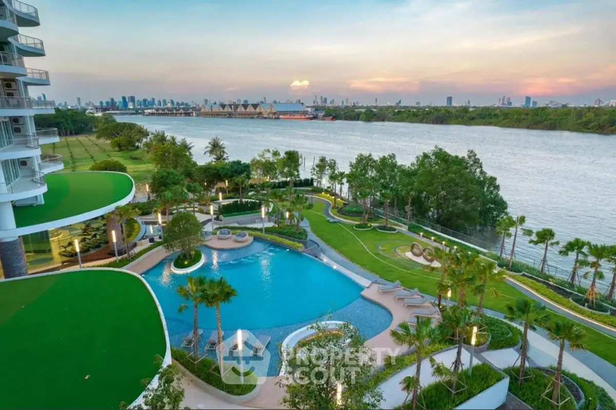Luxurious riverside view with pool and lush gardens, perfect for serene living.