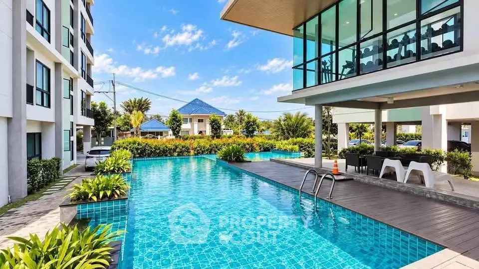 Luxurious apartment complex with stunning outdoor pool and modern architecture.