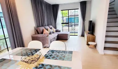 Modern living room with stylish decor and large windows in a contemporary home.