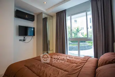Cozy bedroom with modern decor and large window overlooking garden view.