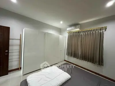Spacious bedroom with modern wardrobe and cozy ambiance