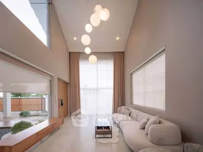 Elegant modern living room with high ceilings and stylish lighting