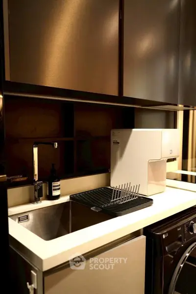 Modern kitchen with sleek cabinetry, stainless steel sink, and built-in appliances for a stylish urban living.