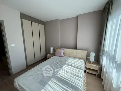 Bright and cozy bedroom with modern furnishings and ample natural light