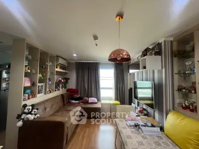 Charming living room with cozy sofa, stylish shelves, and modern lighting in a well-lit apartment.