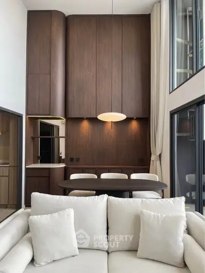 Modern living room with high ceilings and elegant wood paneling