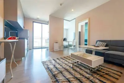 Modern living room with stylish decor and open kitchen layout in a bright apartment.