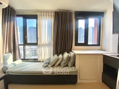 Modern apartment with cozy window seating and city view