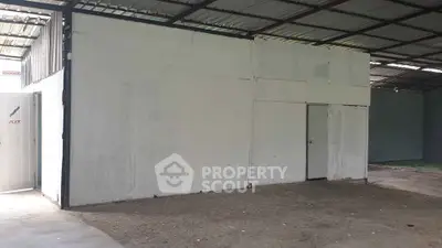 Spacious industrial warehouse with metal roofing and ample storage space.