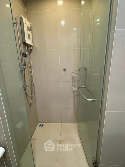 Modern bathroom with glass shower enclosure and sleek fixtures